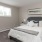 Bedroom with large bed, ensuite. queen bed and nightstands.