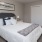 Bedroom with large bed, ensuite. queen bed and nightstands.